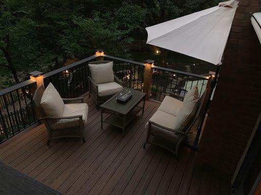 deck with furniture and lighted posts