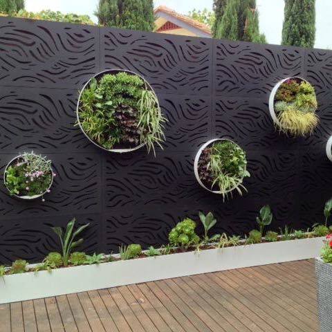 Metal privacy wall with live plants